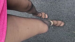 Renee` wearing black pantyhose, rainbow anklet, high fuck me heels, pink sparkley mini dress in public, outdoors