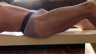 Stretching and Twisting on Table in Purple Underwear for Pain Relief